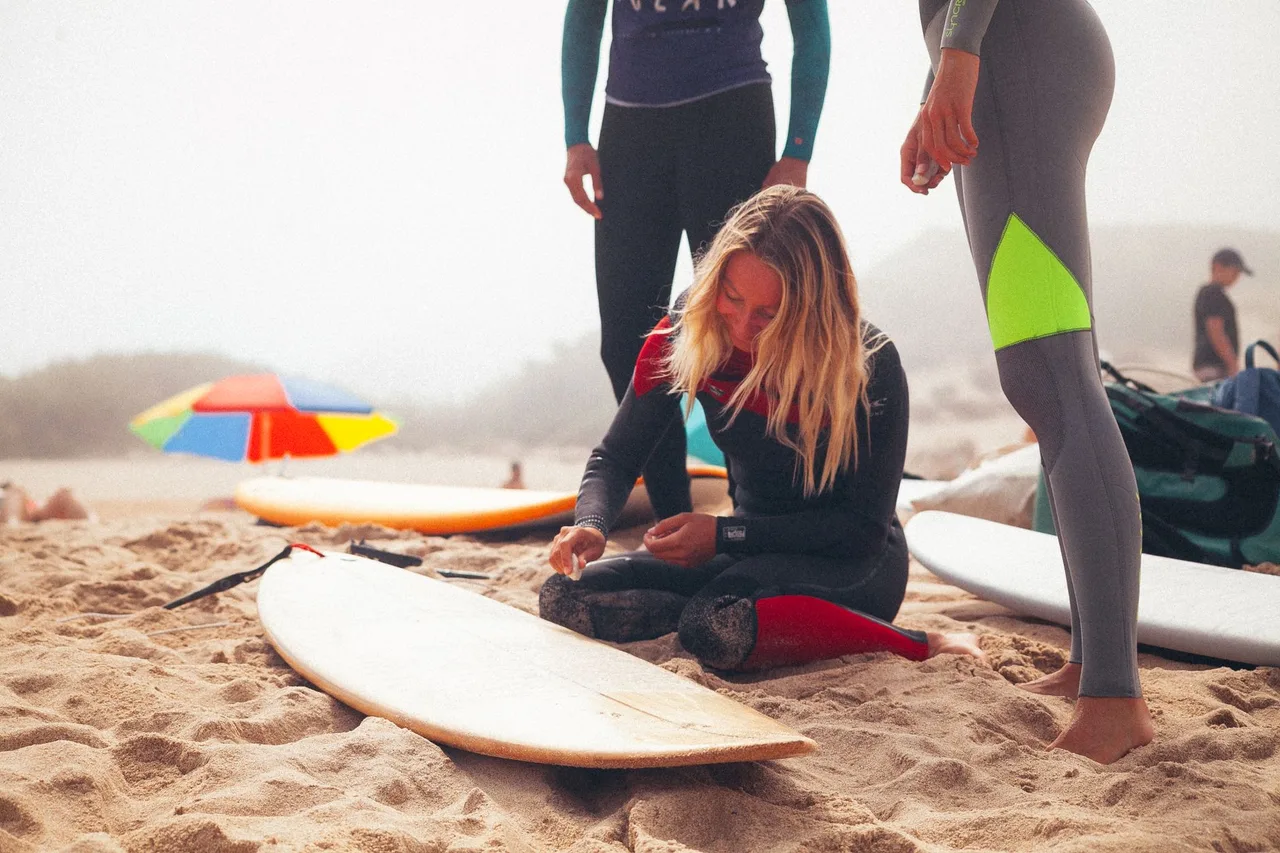 Grupo de surfistas a preparar as pranchas numa praia da Ericeira